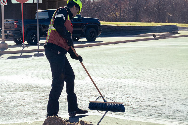 Hazmat-Cleanup-Dallas-North-Texas-Spill-Response-Worker-Cleaning-Road Hazmat Cleanup Dallas North Texas Spill Response Worker Cleaning Road With Broom